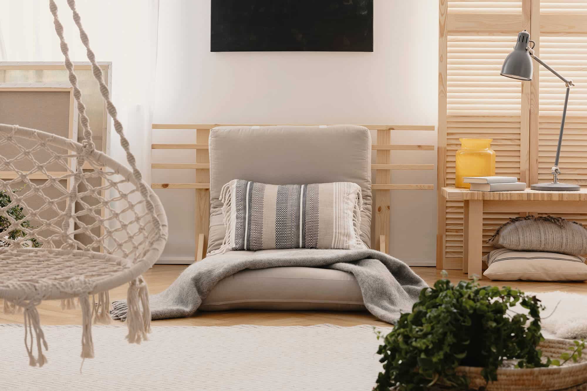 pillow-and-blanket-on-grey-futon-in-boho-bedroom-i-2021-08-26-15-45-34-utc-1.jpg